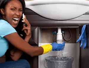 Emergency plumbing repair for a leaking sink drain under a bathroom vanity in Nashville, TN