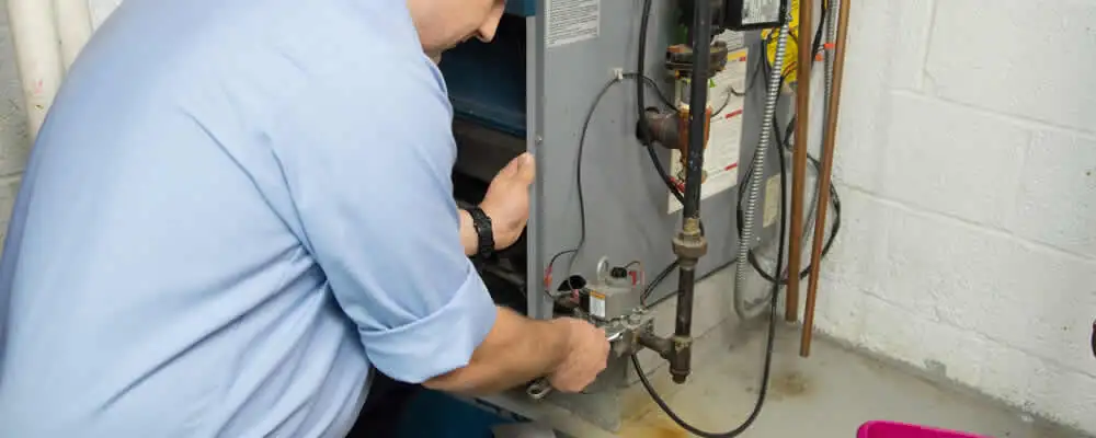 Furnace repair technician inspecting and servicing a home heating system in Nashville, TN