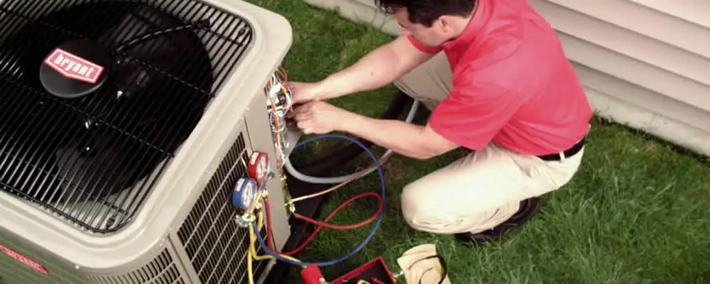 HVAC technician servicing an outdoor air conditioner unit in Nashville, TN