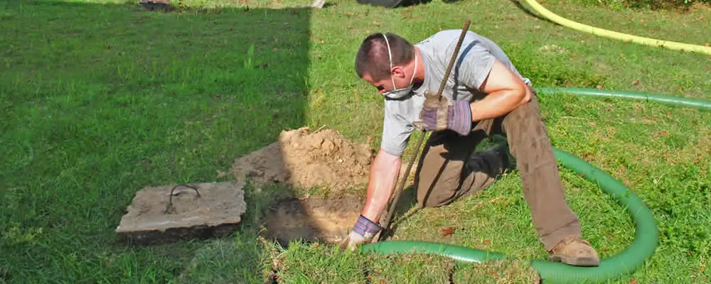 Septic pumping technician servicing a residential septic tank in Nashville, TN